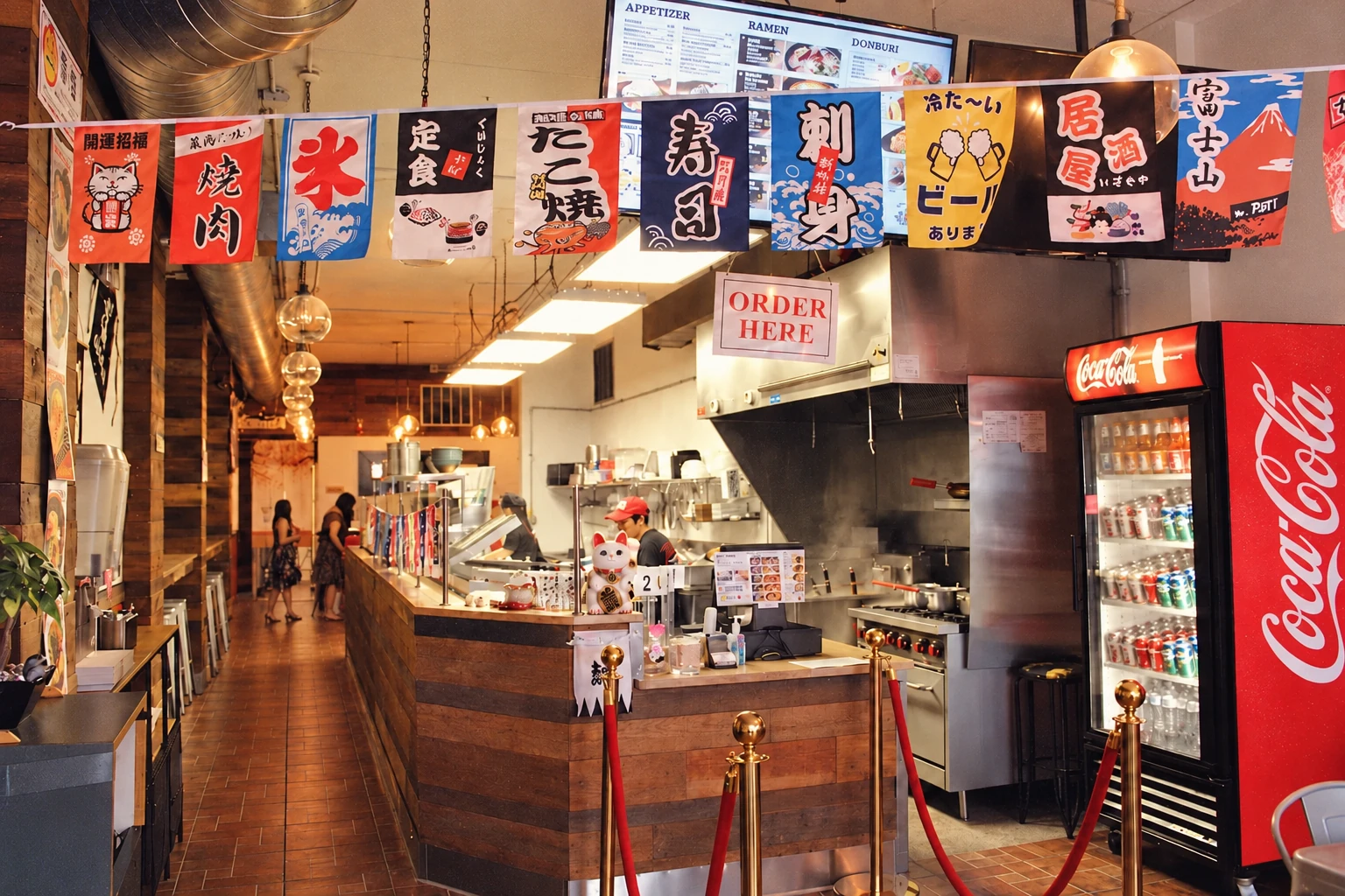 Colorful banners and the wooden counter inside Tenka Ramen